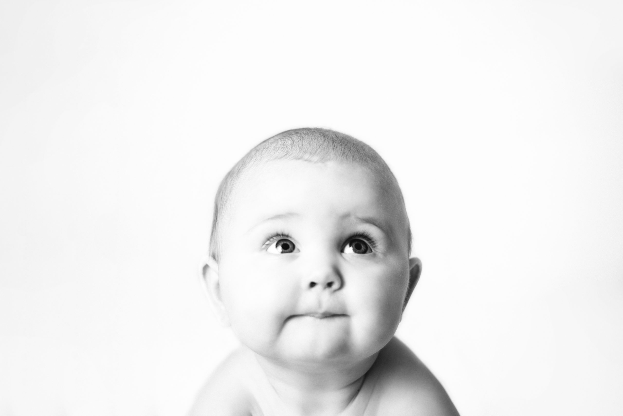 Image contains a baby looking up at the title Cedar Rapids Child Photography