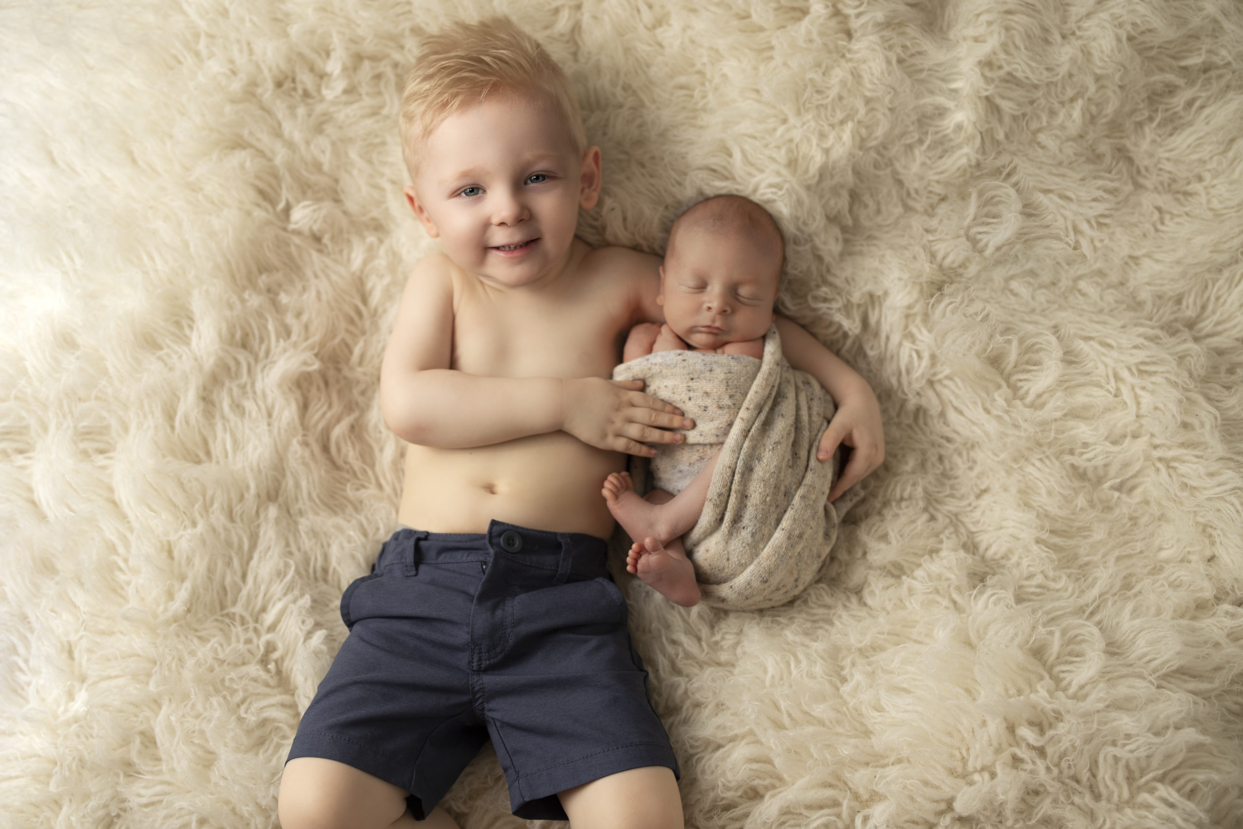 Brother holding baby | Cedar Rapids Newborn photoshoot | Cedar Rapids Newborn Photography